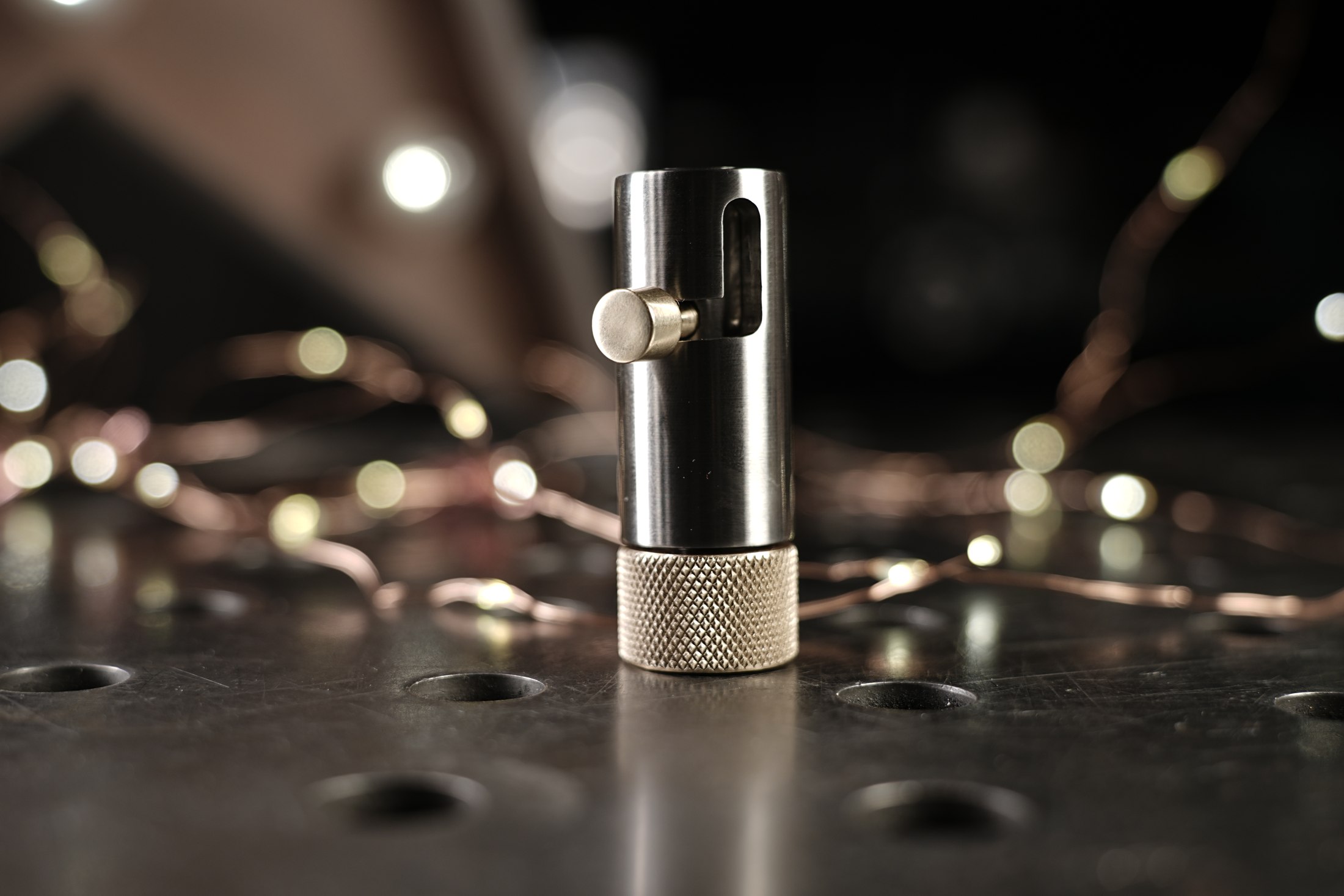 Handcrafted metal spinner standing on a workshop table